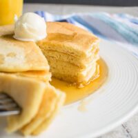 forkful of homemade pancakes being taken from a stack