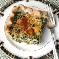 slice of spinach ricotta pie on a plate with fork