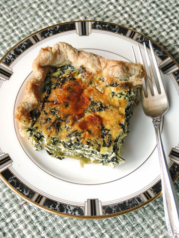 slice of spinach ricotta pie on a plate with fork
