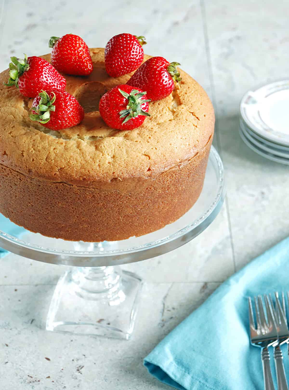 Low-Fat Pound Cake topped with Strawberries on a cake stand