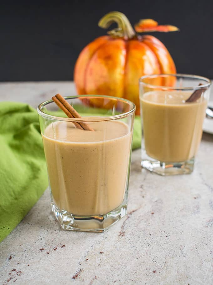 Photo of two glasses of pumpkin smoothies with cinnamon sticks