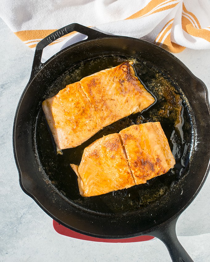 Overhead photo of cast iron skillet with 10-Minute Maple-Glazed Salmon