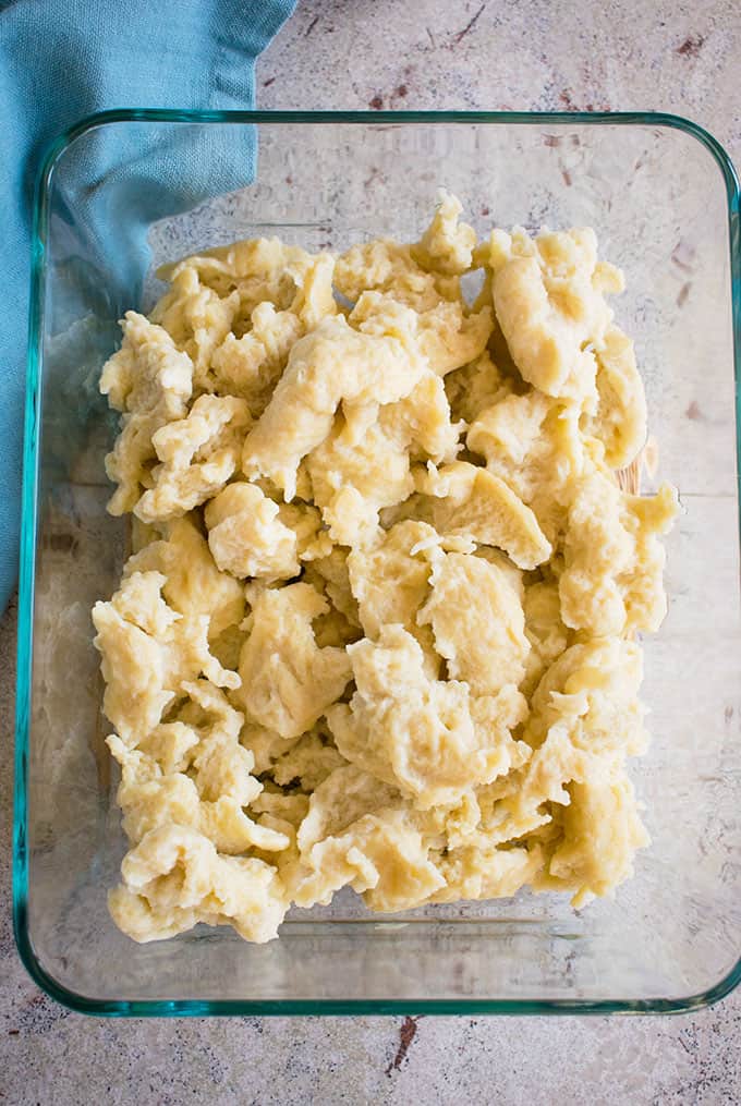 overhead photo of cooked dumplings in a glass serving dish 