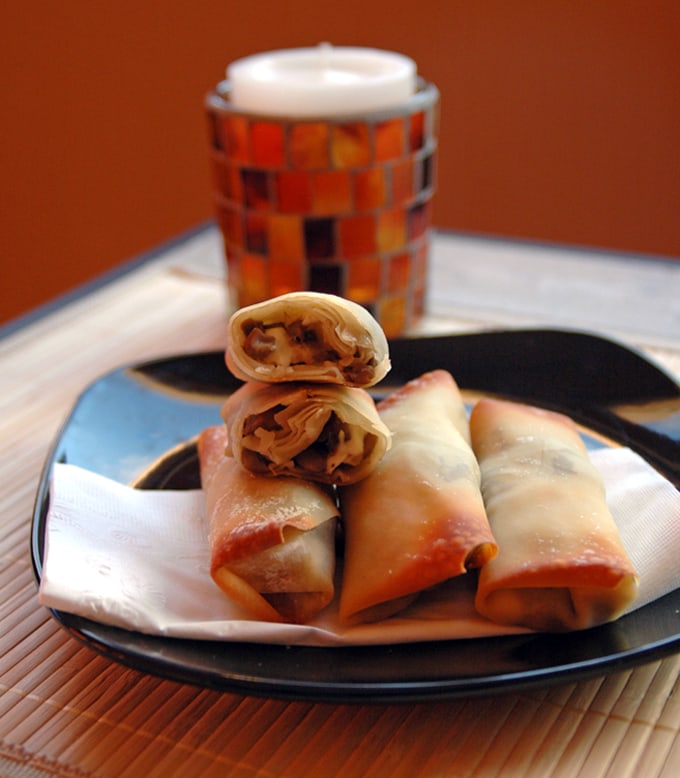 Crispy Mushroom Onion Feta Rolls stacked on a plate