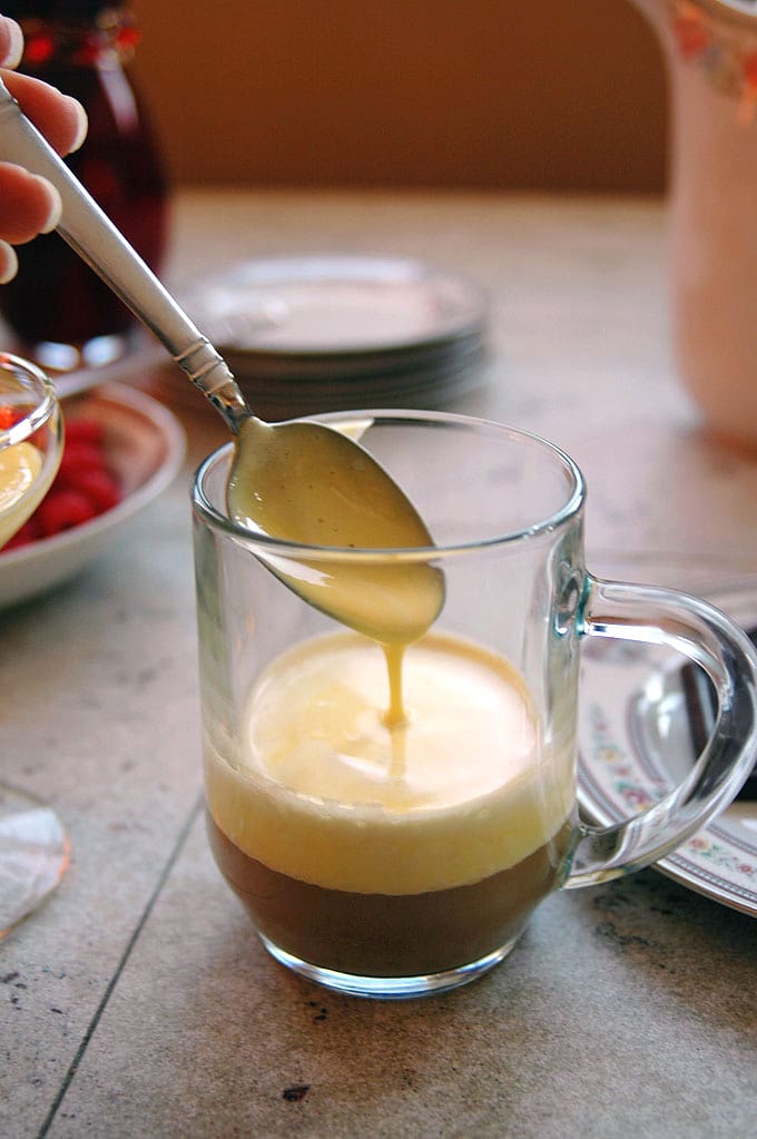 Breakfast Zabaglione with Berries and Espresso in glass mug with spoon 