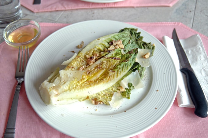 overhead view of Grilled Romaine with Toasted Walnuts and Parmesan on a plate