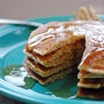 stack of Cinnamon Almond Multigrain Pancakes on a plate with a piece cut out