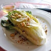 Grilled Romaine with Toasted Walnuts and Parmesan on a plate