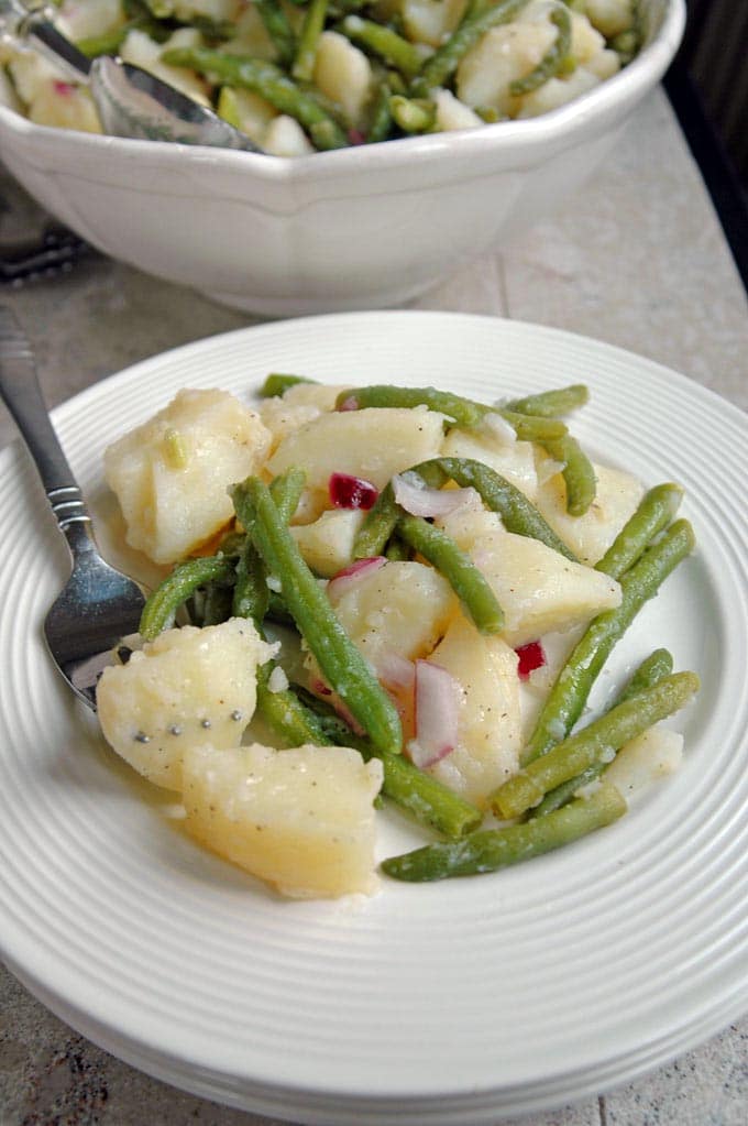 Italian Potato Salad with Green Beans on a plate with a fork
