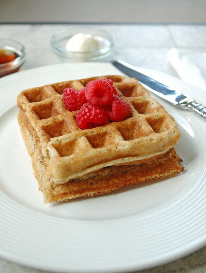 2 Buttermilk Whole Grain Waffles on a plate with a knife