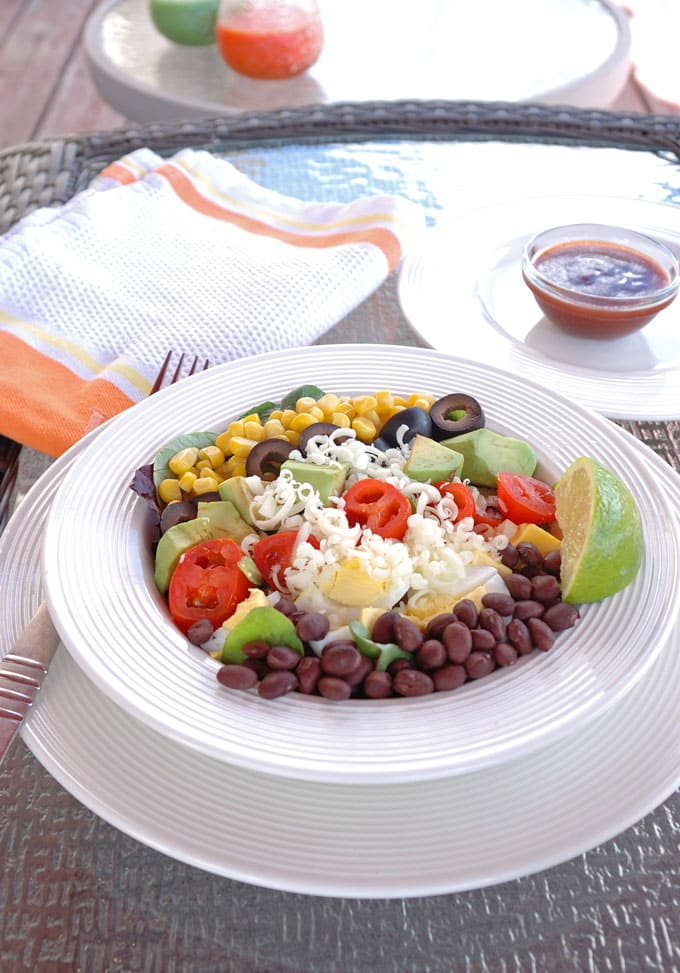 Southwest Salad in a bowl with Catalina Lime Dressing behind it