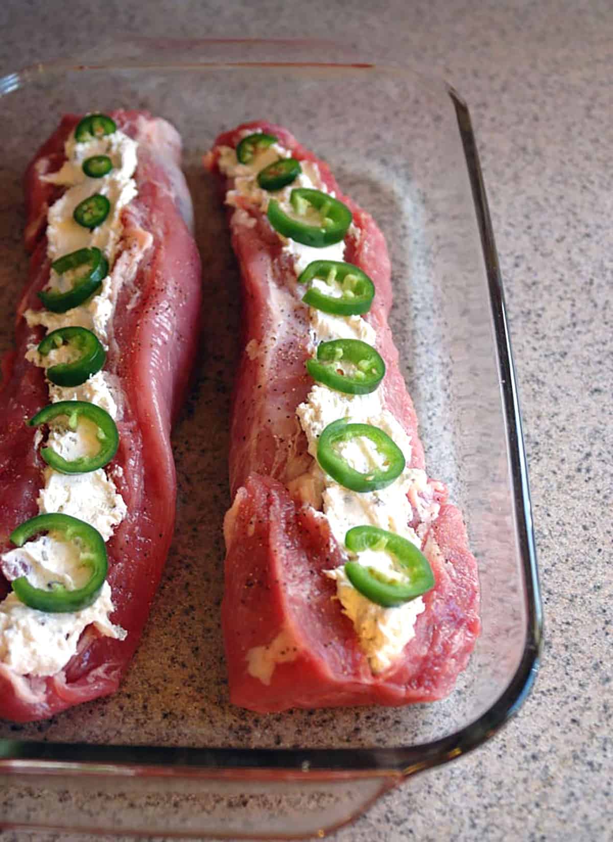 raw stuffed pork tenderloin with cream cheese and jalapenos