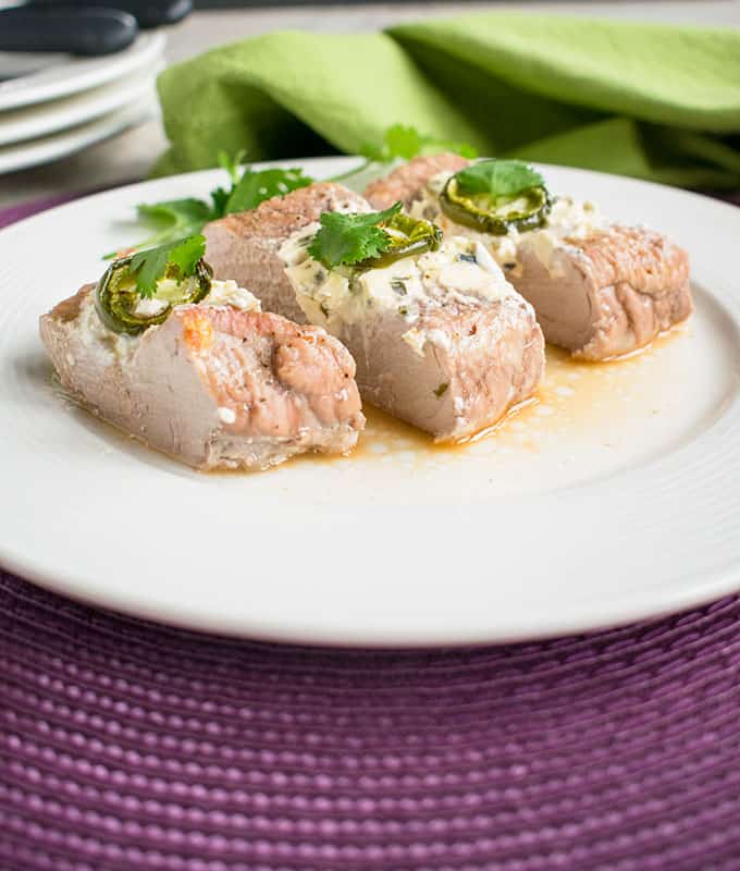 photo of plate with three pieces of stuffed pork tenderloin with cream cheese and jalapenos