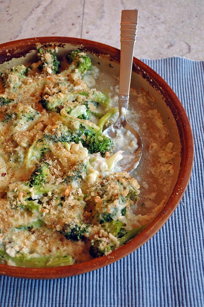 Overhead view of Baking dish of Broccoli and Fontina Gratin and spoon