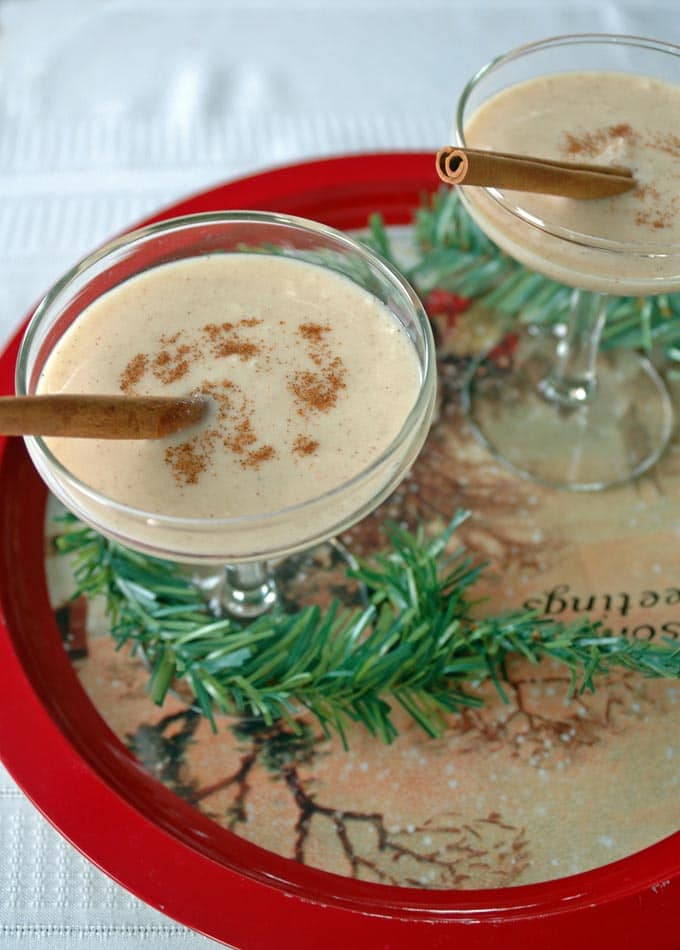 two martini glasses of Coquito (Coconut-Rum Drink) on a tray 