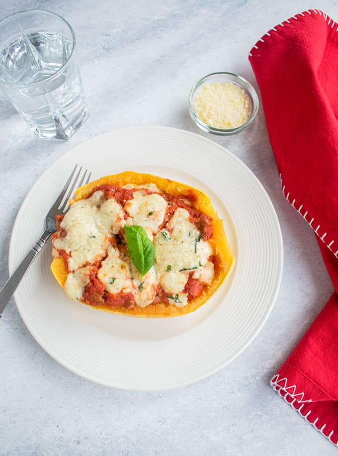 Photo of plate with spaghetti squash lasagna boat and fork