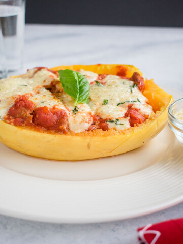 side view of spaghetti squash lasagna boat on a plate