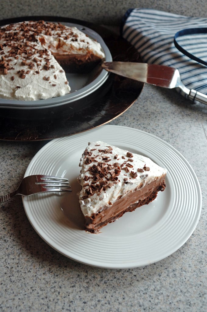 slice of chocolate pie with whipped cream, rest of pie 