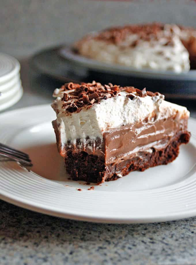 slice of chocolate pudding pie with brownie crust and whipped cream