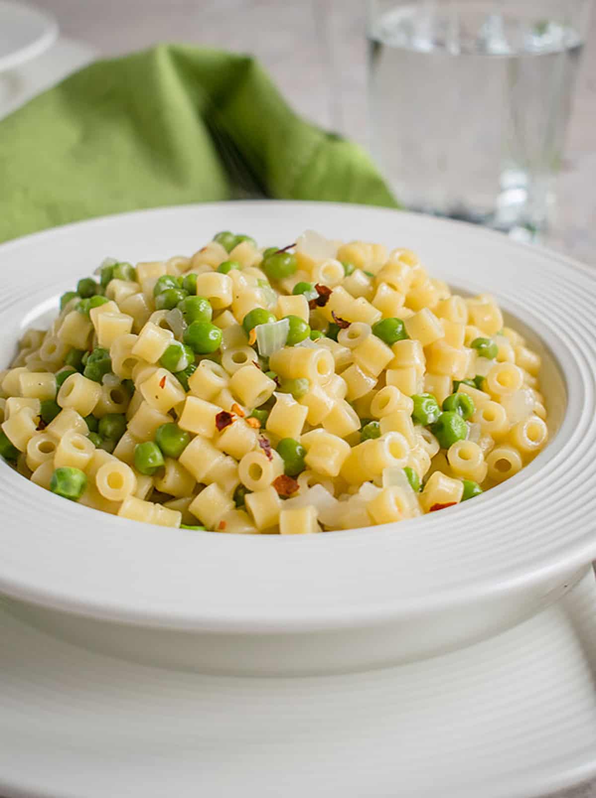 close-up photo of a bowl of pasta e piselli (pasta with peas)