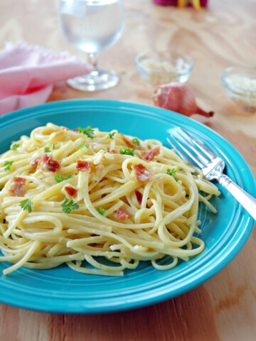Pasta Carbonara with Shallots on a plate with fork