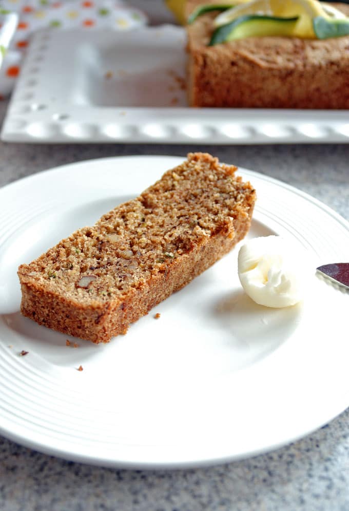 slice of Lemony Whole Wheat Zucchini Bread on a plate with butter