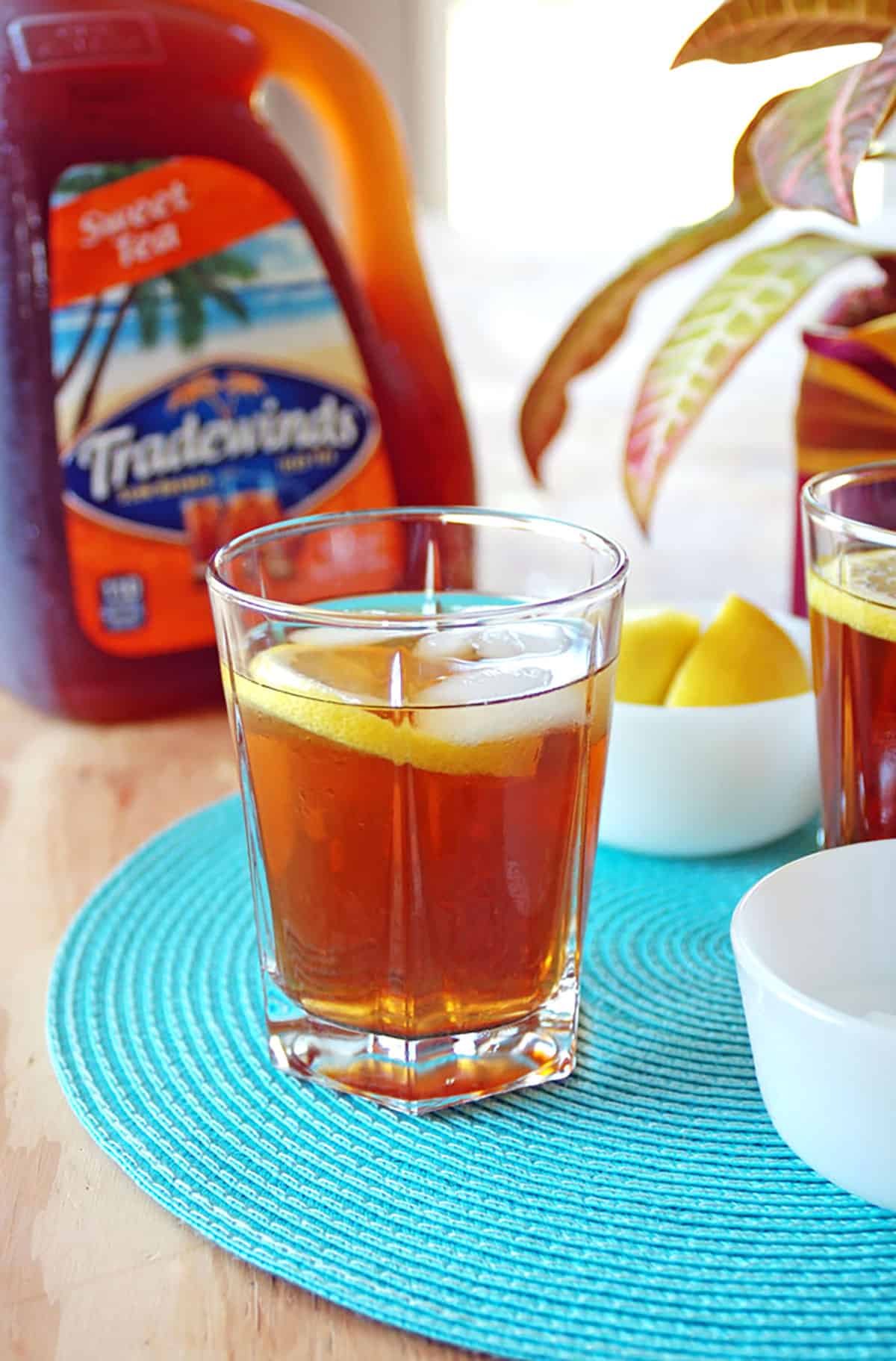 glass of iced tea and rum cocktail with lemon wedge