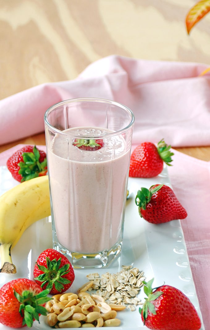 glass of Peanut Butter and Jelly Smoothie with banana, strawberries, peanuts and oats