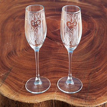 2 custom champagne glasses on a wooden surface