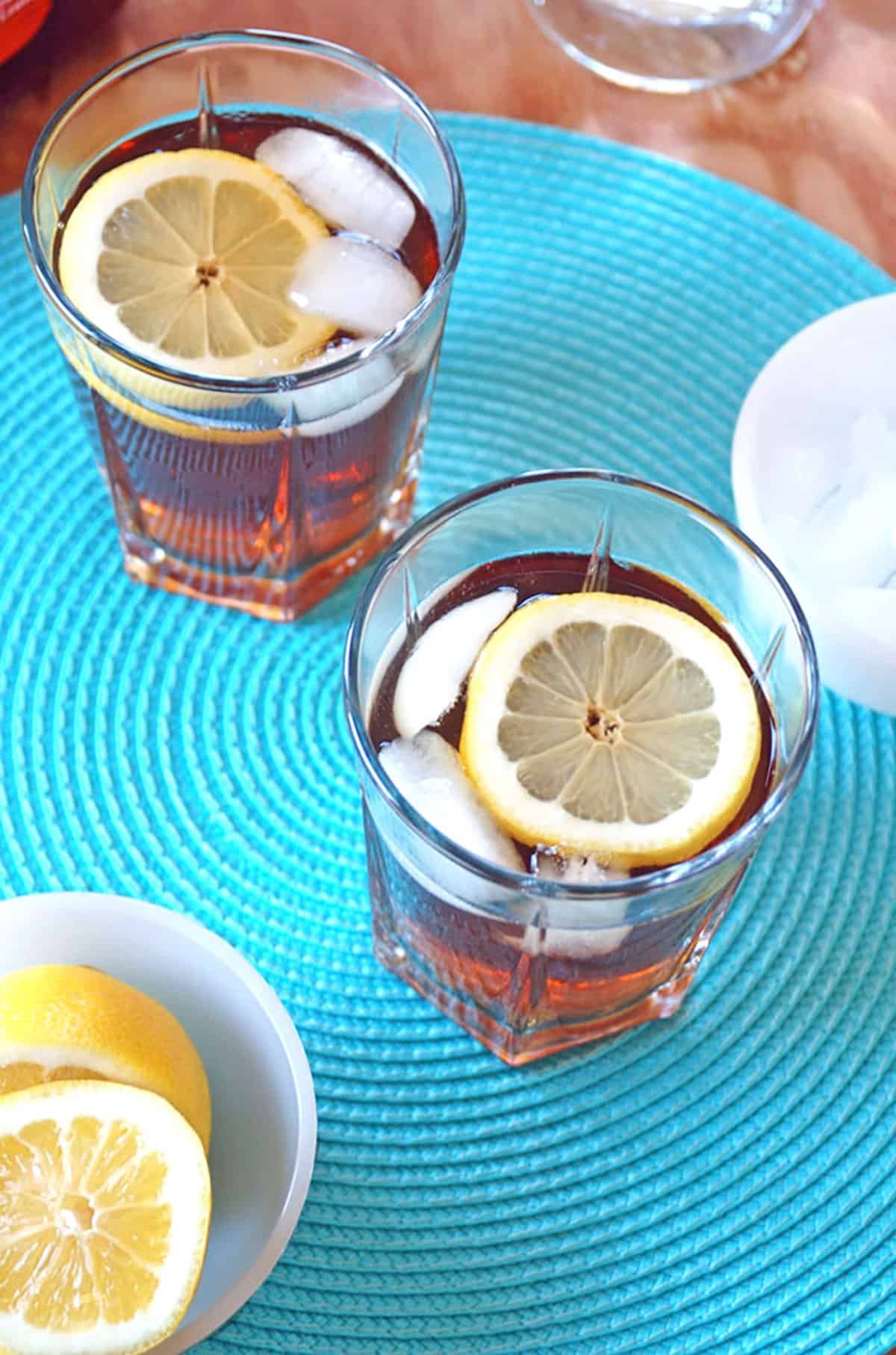 overhead view of two glasses of iced tea and rum cocktails