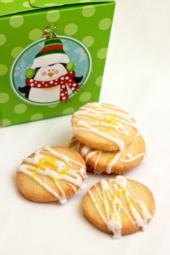 stacked simple lemon cookies in front of a box with a penguin