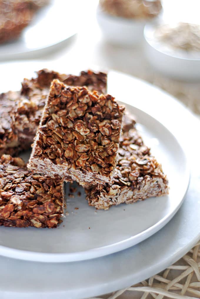 chocolate peanut butter granola bars stacked on a plate