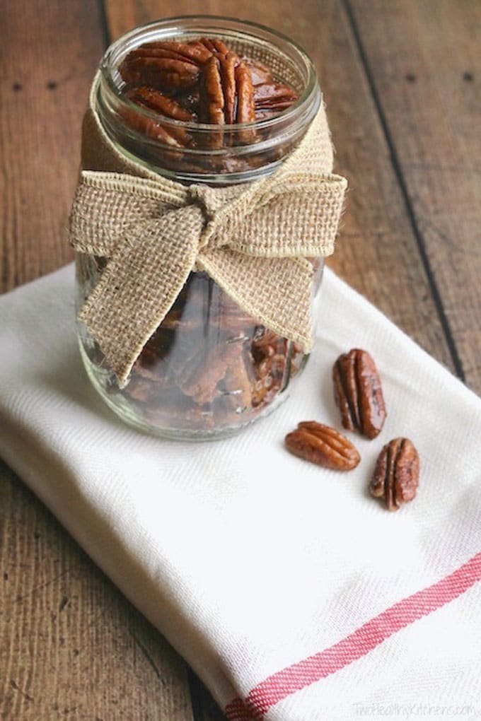 Candied pecans in a mason jar with a bow