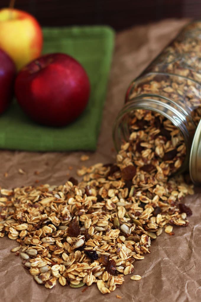 apple pie granola pouring out of a mason jar