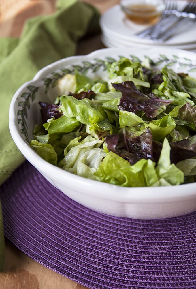 bowl of Italian green salad with homemade dressing and a napkin