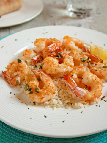 plate of Baked Parmesan Shrimp with Garlic Butter over rice
