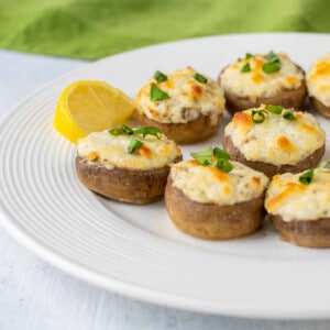 plate of stuffed mushrooms with cheese.