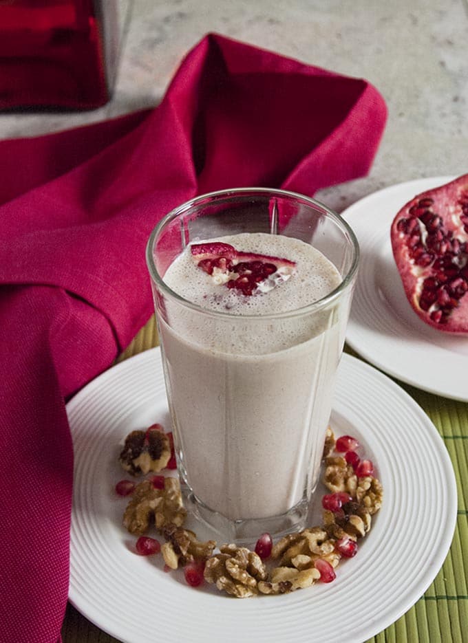Pomegranate Smoothie with Banana and Walnuts in a glass