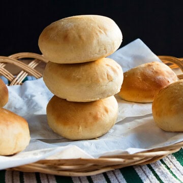 homemade hamburger buns in a wicker bowl