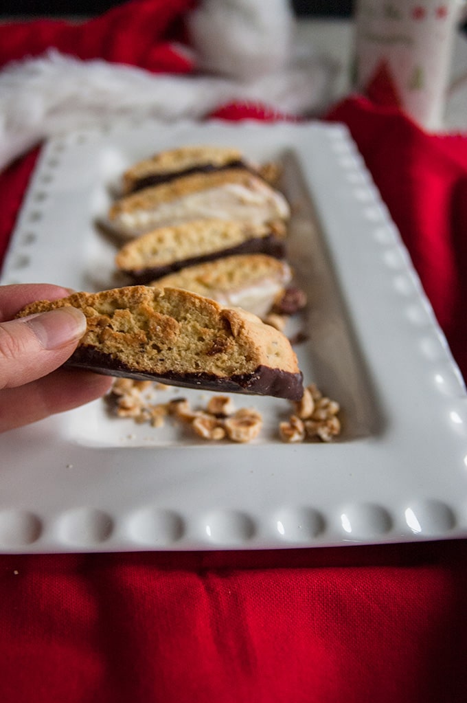 hand showing the side of Chocolate-Dipped Hazelnut Biscotti