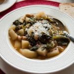 close-up of Tuscan white bean soup with escarole and potatoes in a bowl