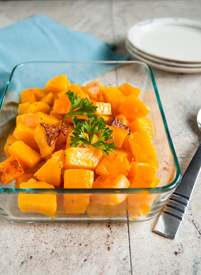 roasted butternut squash cubes in a glass pan