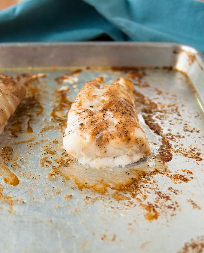 baked cod with coffee butter on a sheet tray