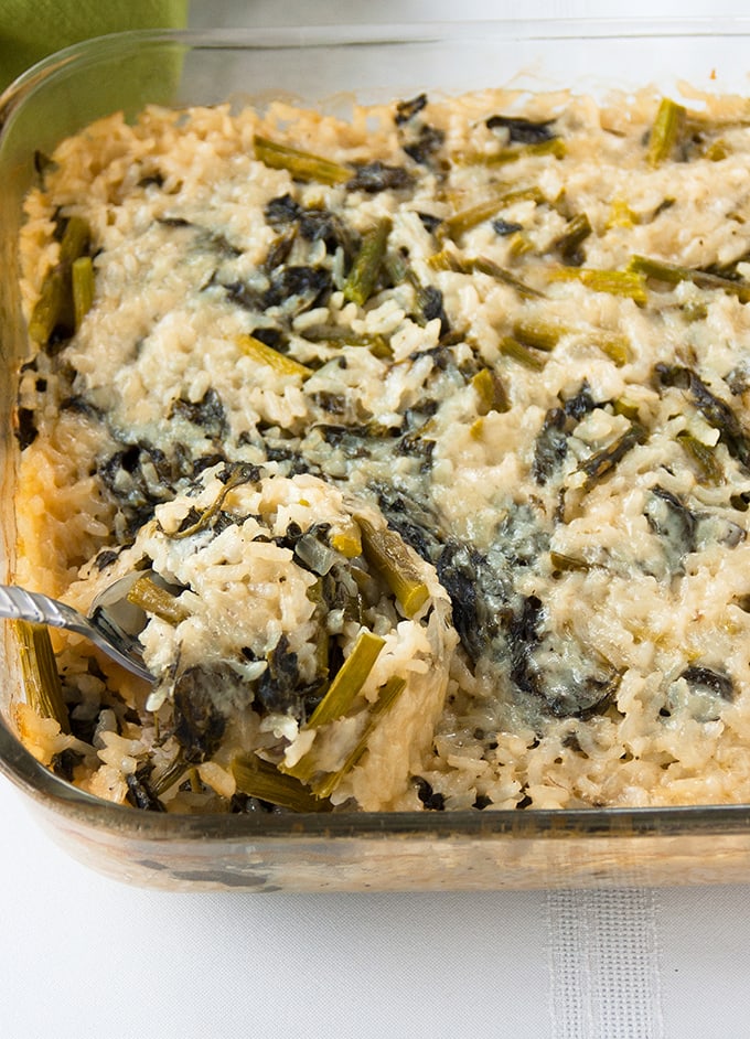 close-up of Baked Vegetable Risotto with Asparagus and Spinach in glass pan