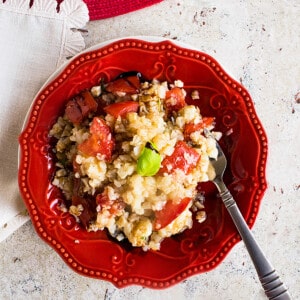 plate of cauliflower rice salad with tomatoes, basil, balsamic glaze