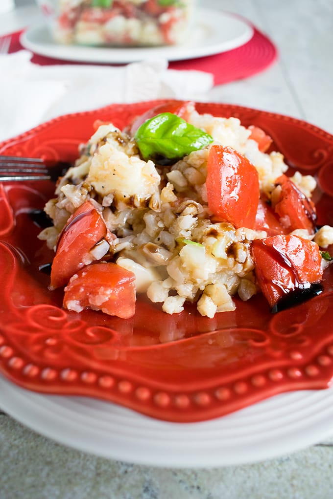 Cauliflower Rice Caprese on a plate with fork