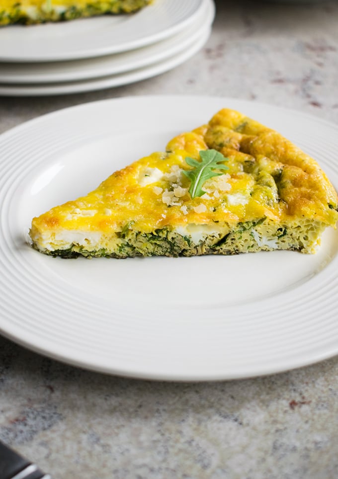 slice of baked arugula frittata on a plate