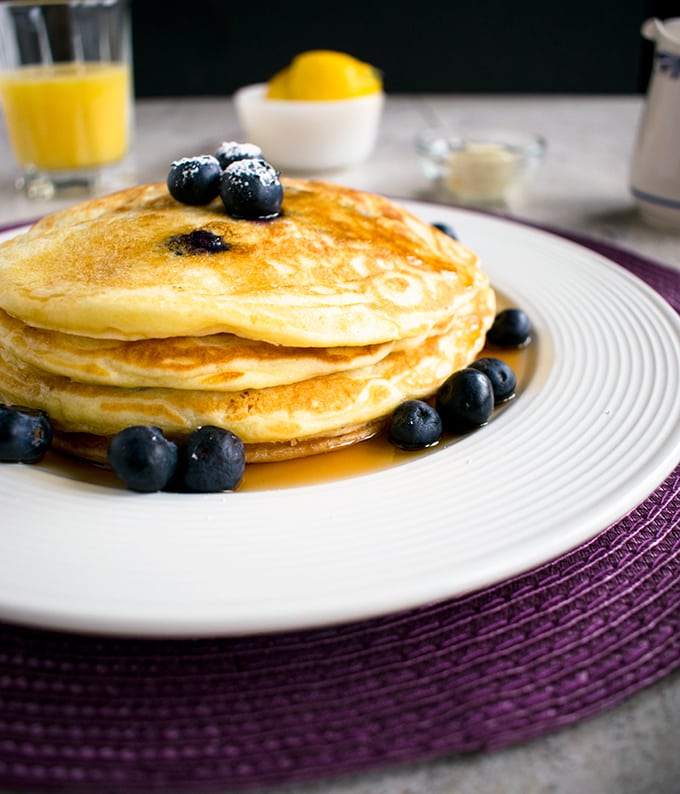 lemon-blueberry pancakes drenched in maple syrup 