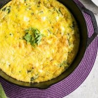 baked arugula frittata in iron skillet