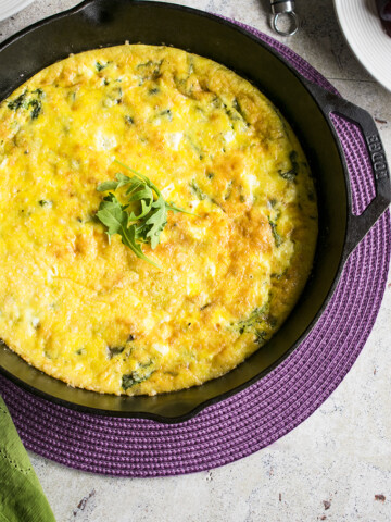 baked arugula frittata in iron skillet
